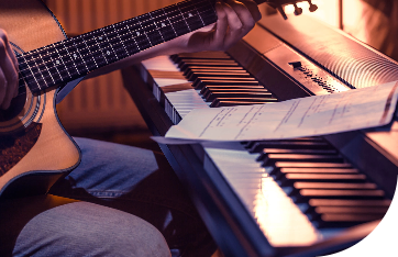 man-playing-acoustic-guitar-piano-close-up-recording-notes-beautiful-color-background-music-activity-concept